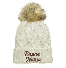 White knit beanie with fur pom-pom and 'Bronx Native' text on a white background