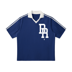Blue vintage-style jersey with white 'BR' logo, ribbed texture, and striped sleeves — bold streetwear apparel.
