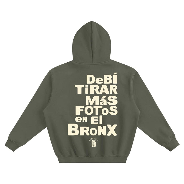 Olive green hoodie with 'Debí Tirar Más Fotos en El Bronx' text, NYC streetwear style