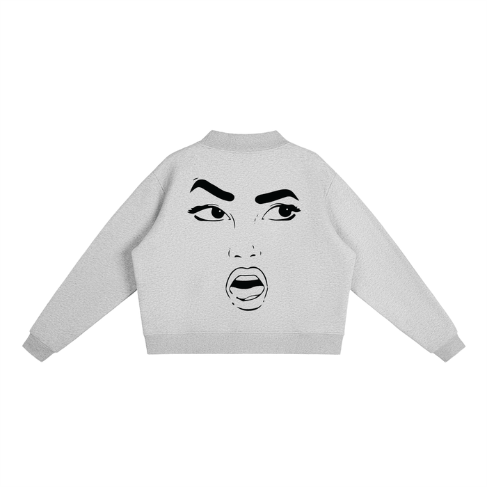 Gray cropped hoodie with bold black graphic face print, streetwear style