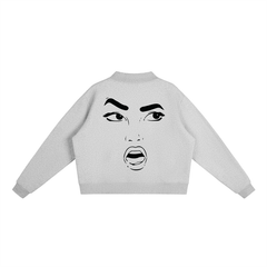 Gray cropped hoodie with bold black graphic face print, streetwear style