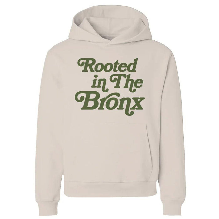 Cream hoodie with 'Rooted in The Bronx' text, NYC streetwear style