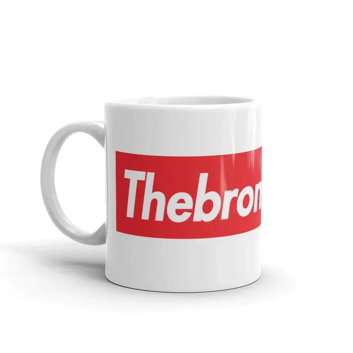 White mug with a red and white 'Thebron' logo on a white background